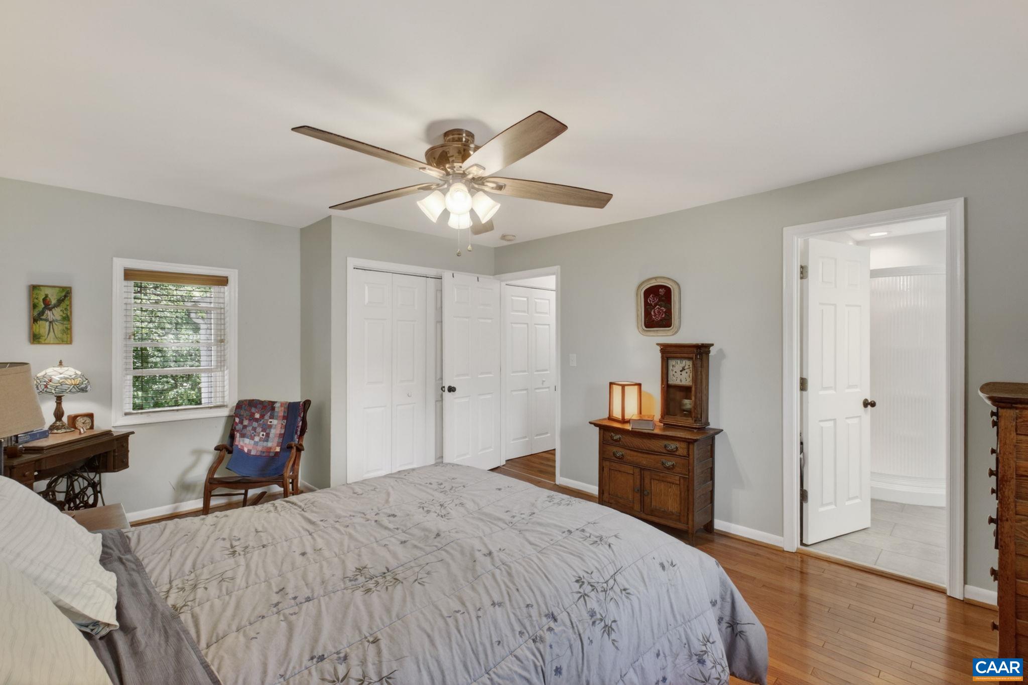 Primary bedroom with door to attached bathroom.