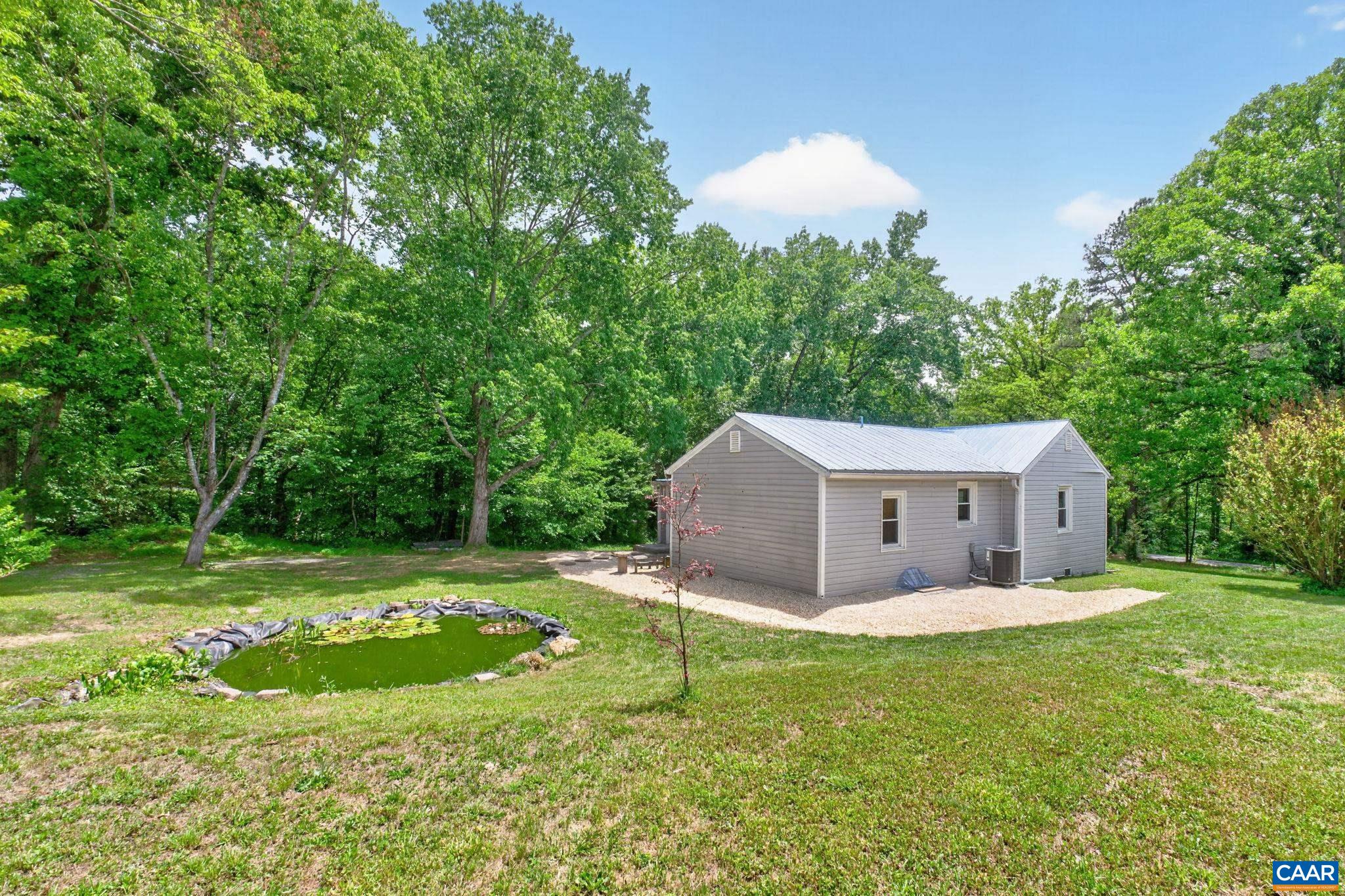 Side view and rear of home with accent pond.