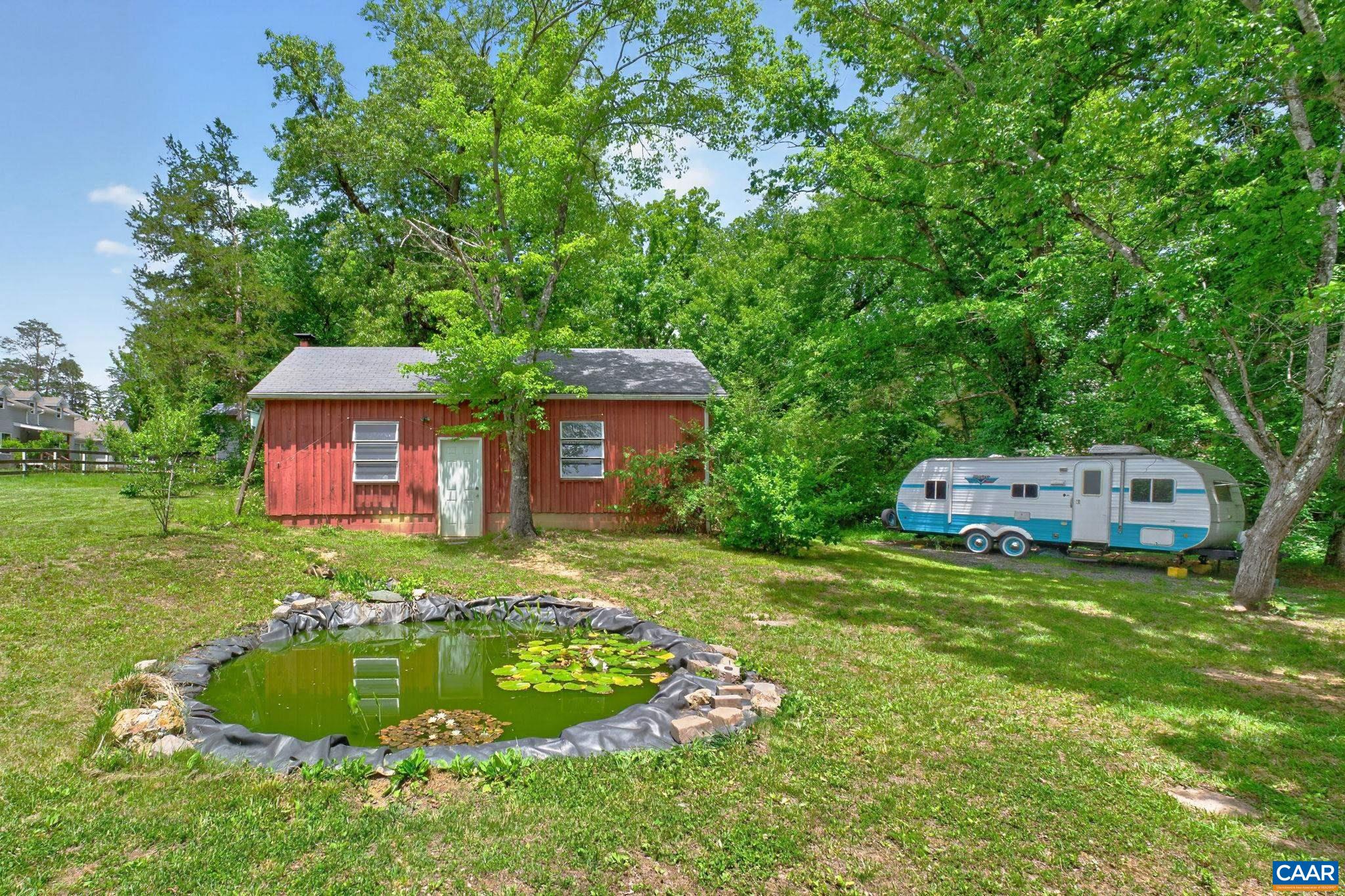 Backyard with small accent pond and wonderful barn.