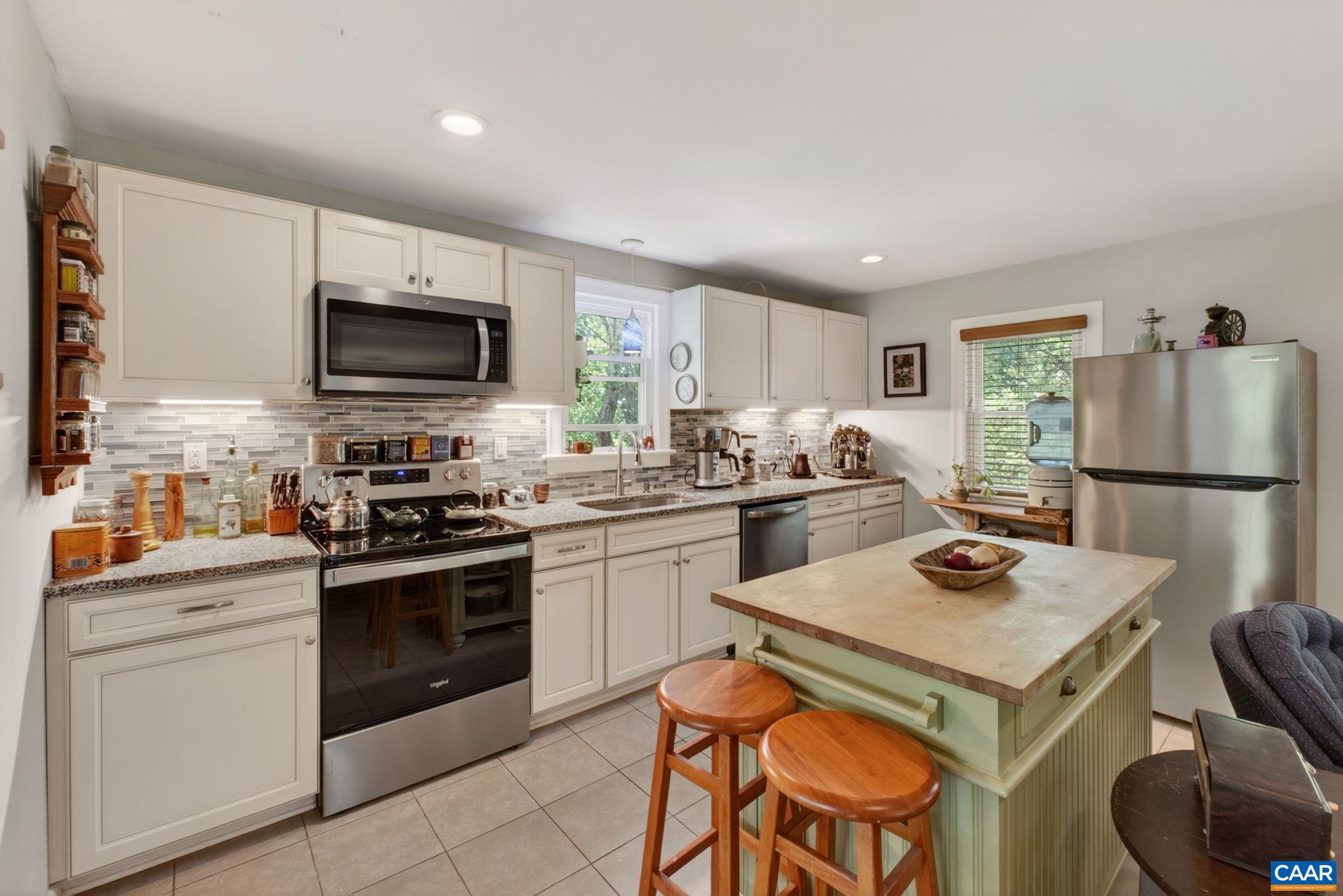 Tiled kitchen and glass tile backsplash.