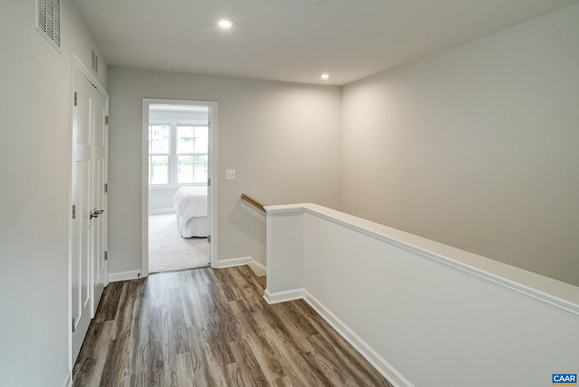 Luxury vinyl flooring continues to the bedroom level hallway.