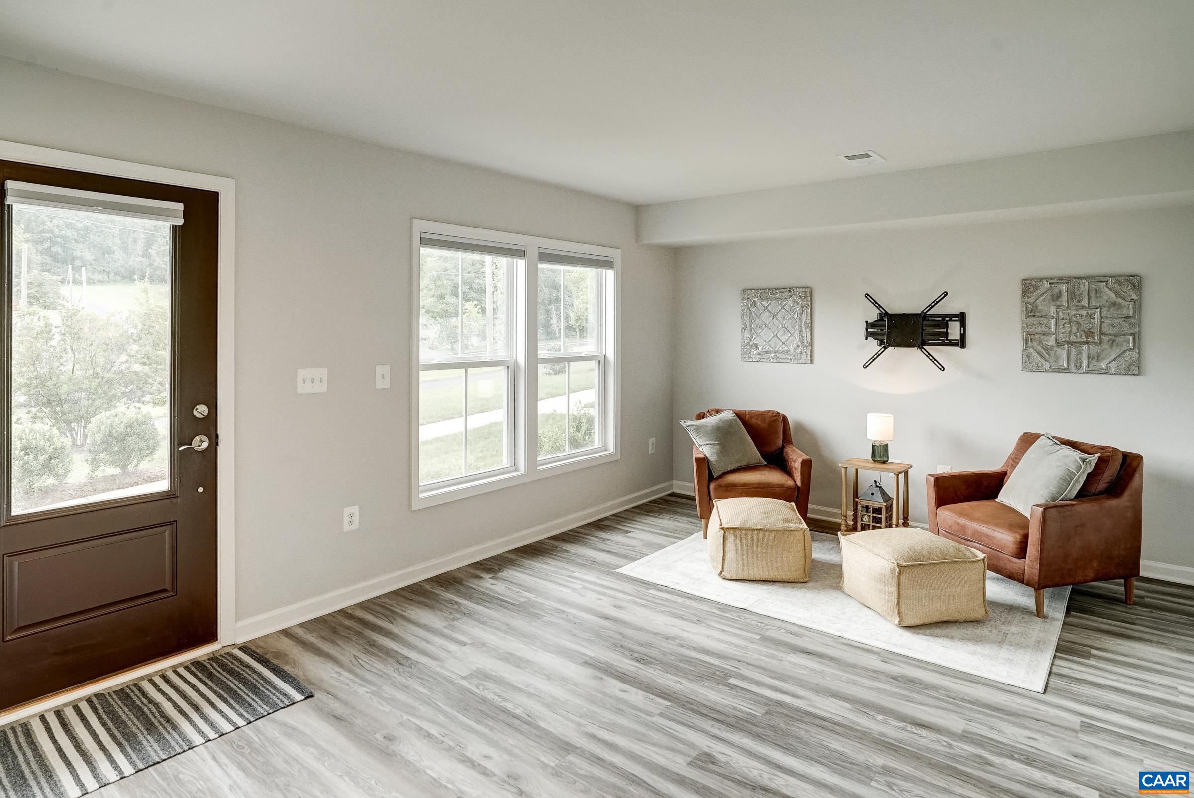 Luxury vinyl flooring, neutral paints and large windows throughout the home.