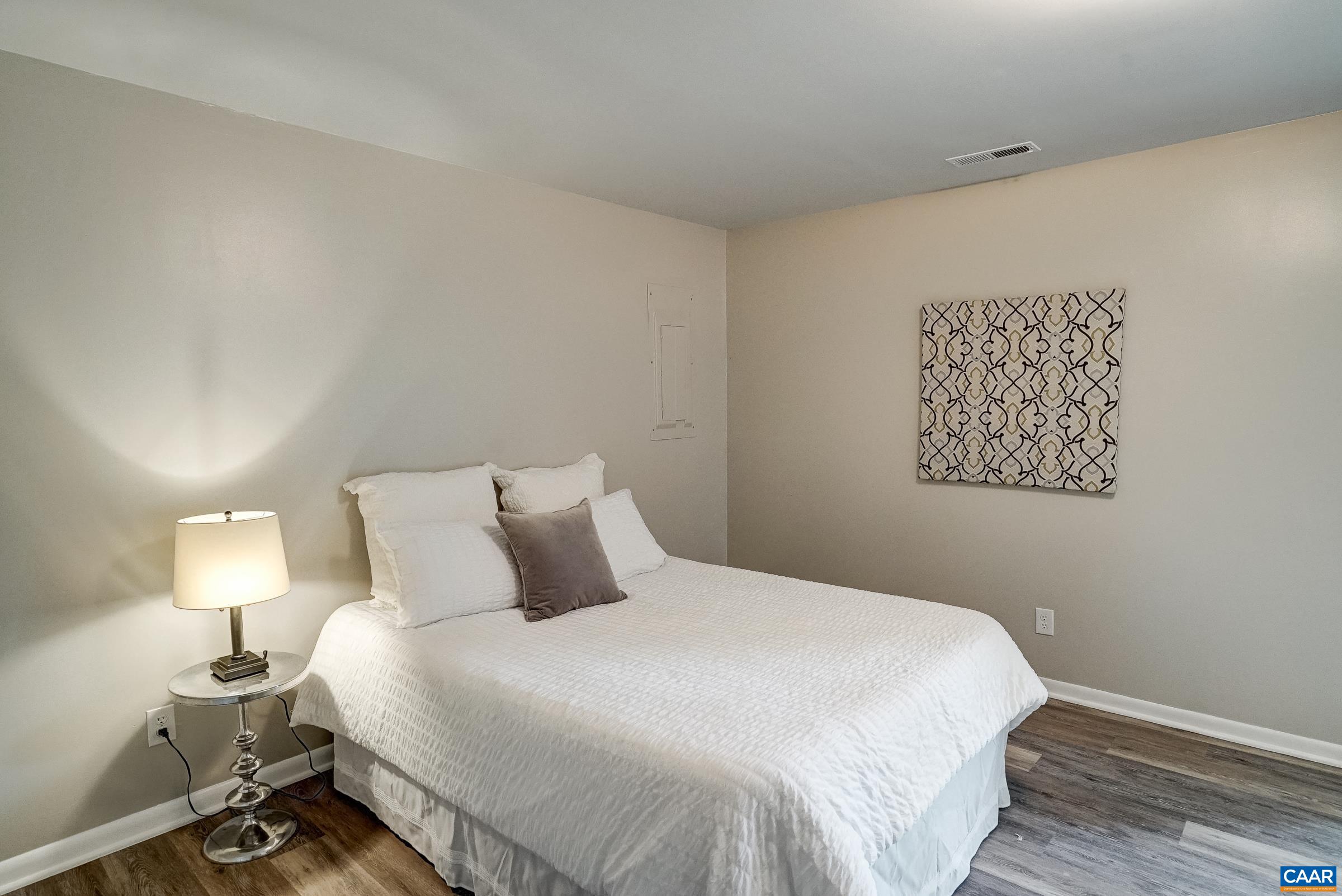 Main level primary bedroom with sliding doors to new deck. Main level primary bedroom with sliding doors to new deck.