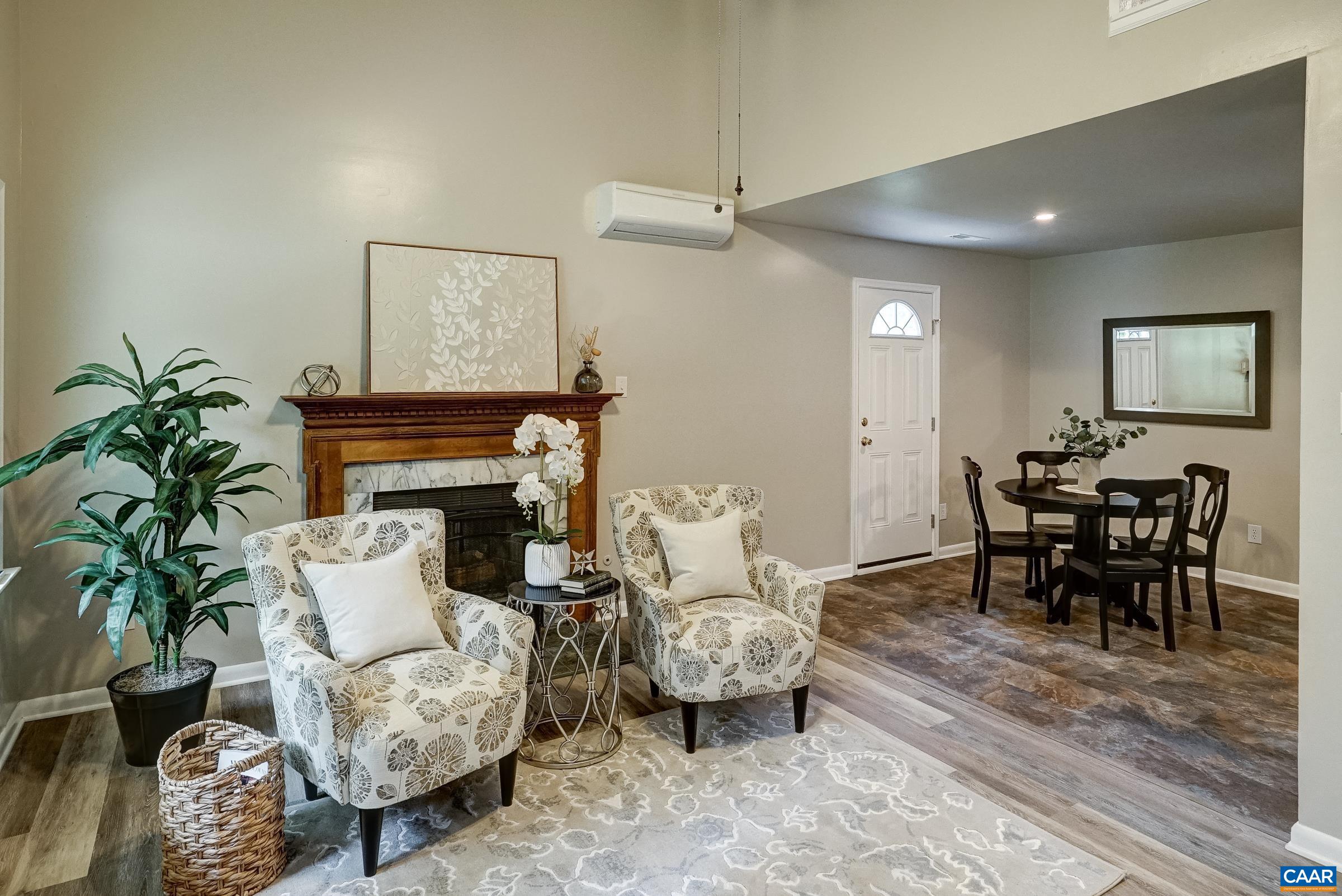 Vaulted great room with fireplace and ceiling fan. Vaulted great room with fireplace and ceiling fan.