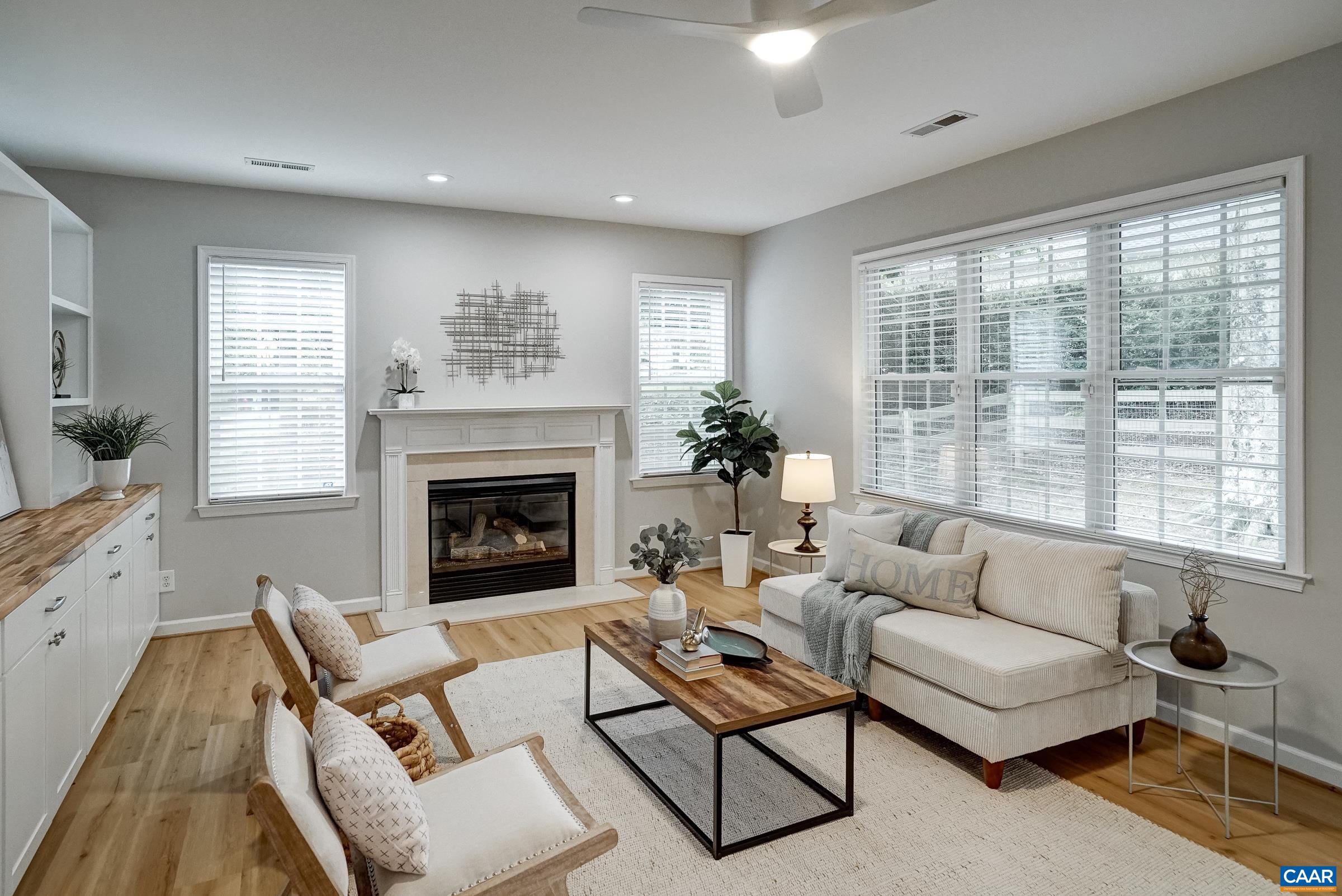 Great room with ceiling fan and gas fireplace.