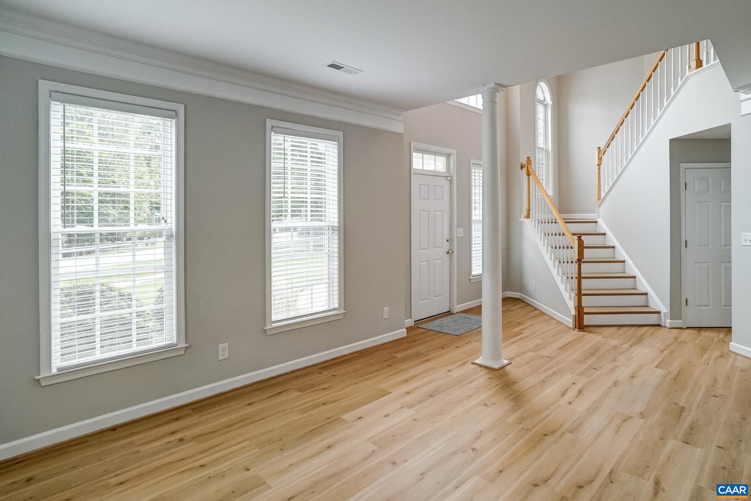 Formal living room at the front of the home offset with columns.