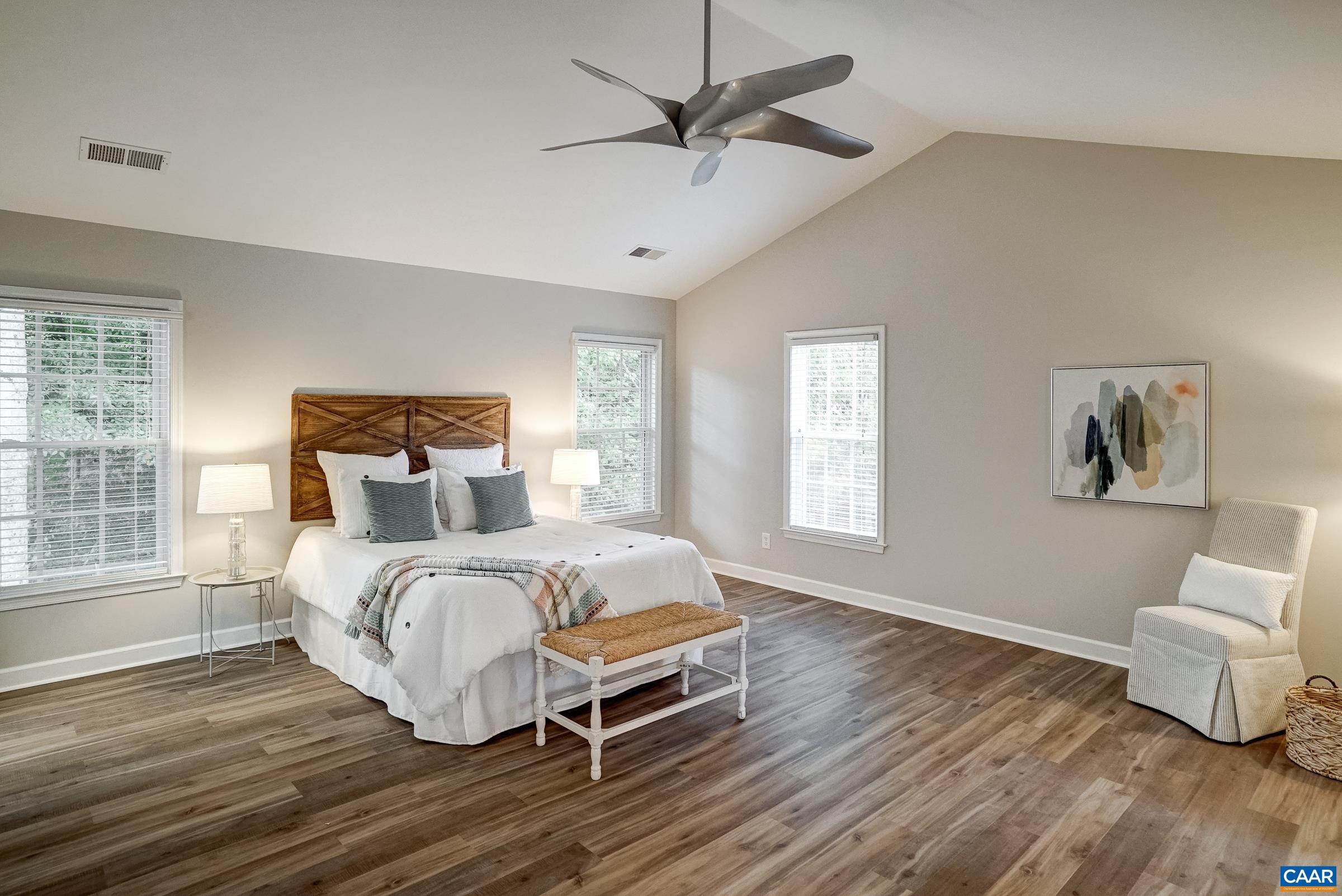 Second floor primary suite with vaulted ceiling and lvp flooring.