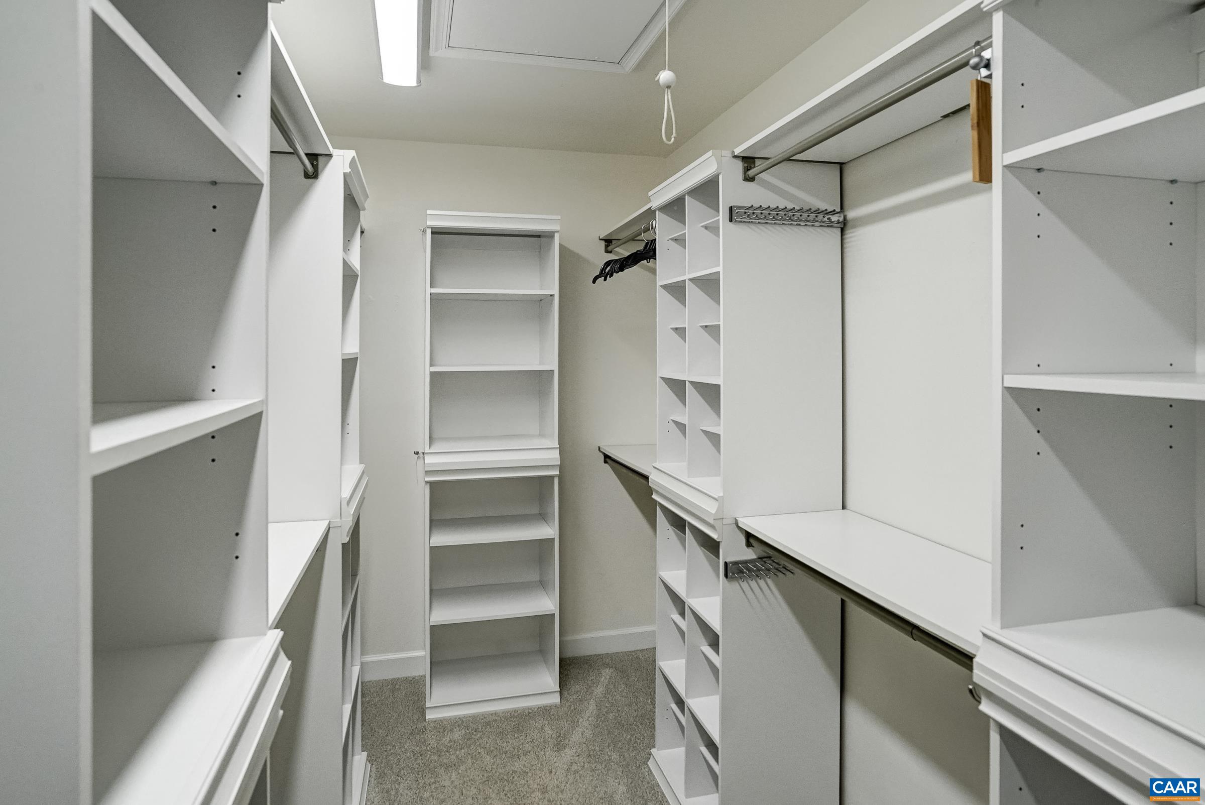 Walk in closet with custom organization.