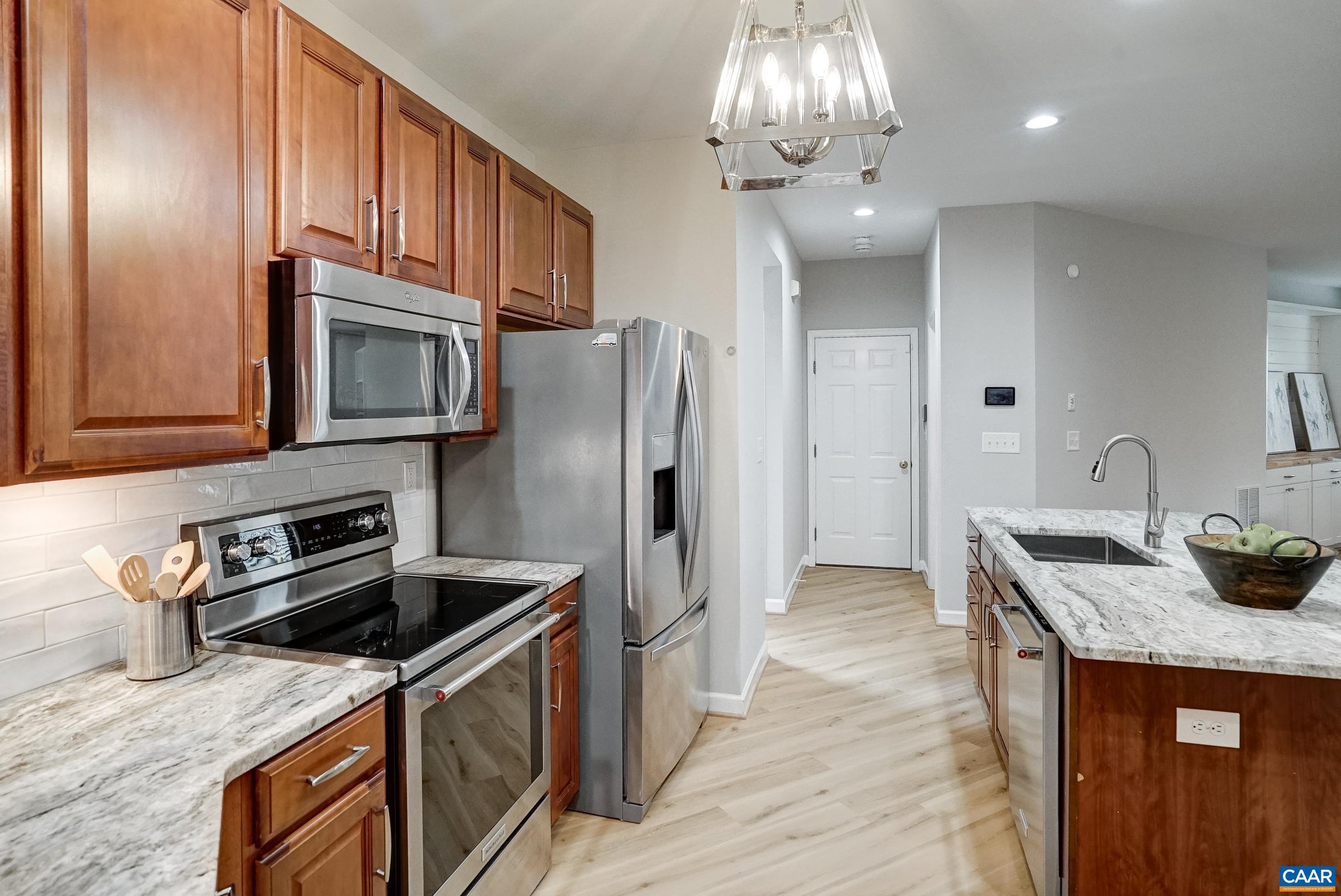 Renovated kitchen with cherry cabinets, granite counters, and new stainless appliances