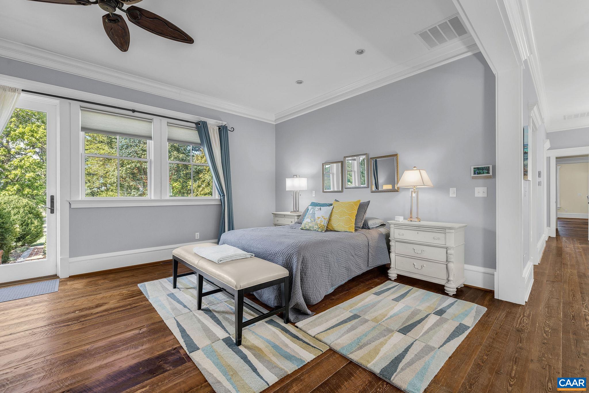 Primary suite with sitting area and fireplace opens to side brick patio