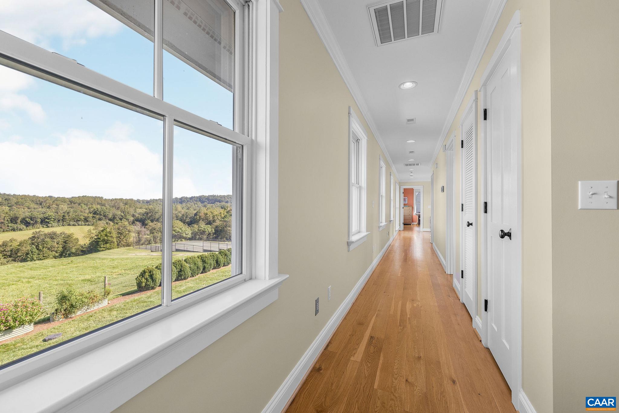 Second floor hallway with wall of windows