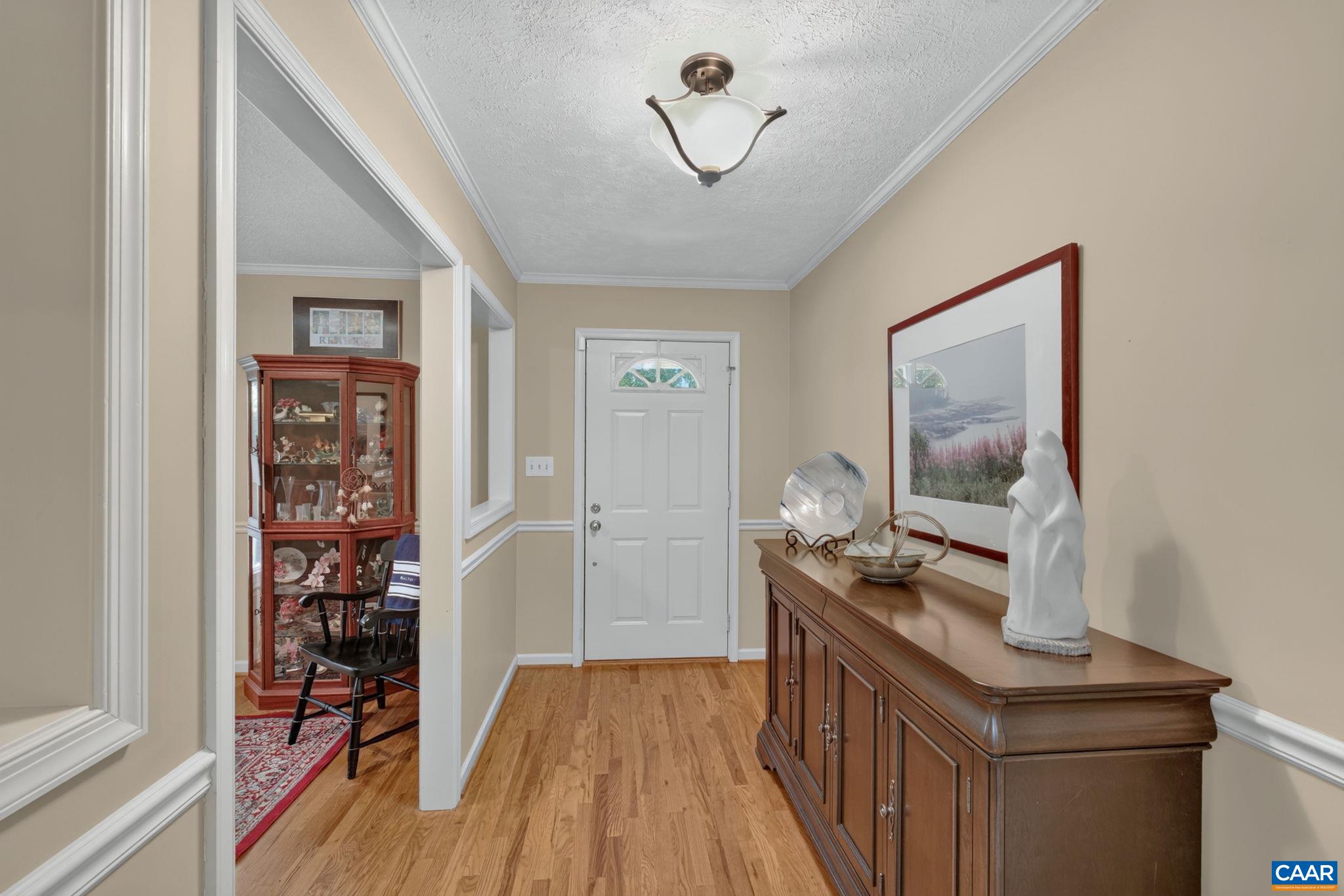 Showing the foyer with Formal Dining Room, with cutouts to the foyer.  The formal Dining Room is currently being used as a home office, although there are several other areas that could also be used for an office.