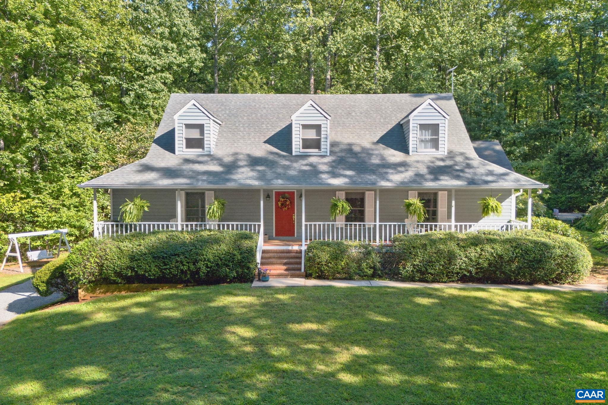Relax on this front porch that stretches across the entire front of the house.