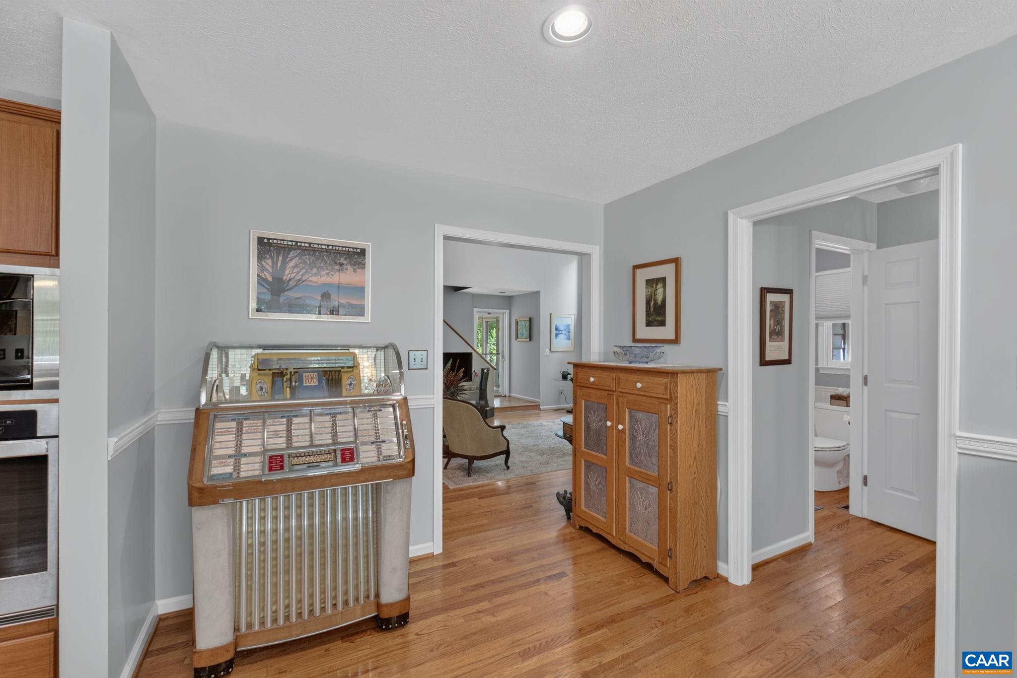 This area can be used as part of the Eat In area or whatever you choose. Photo is showing views to the right of the Half Bath and ahead to the Great Room.  The Great Room is a sunken room with four areas stepping one step down...please be aware!!