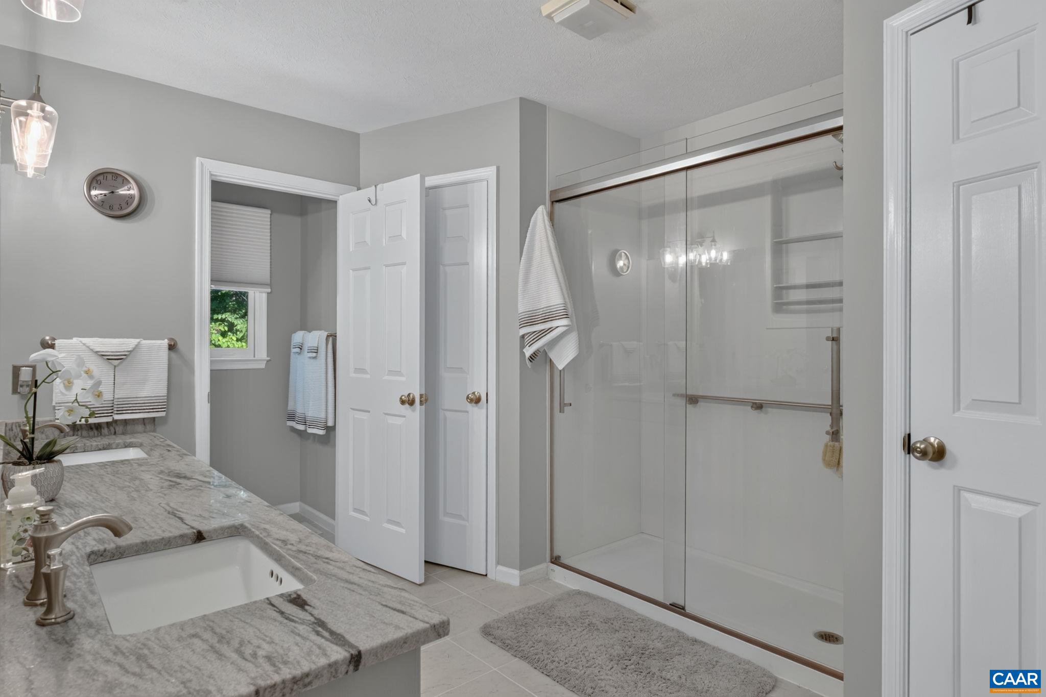 This large bath features a double vanity, (vanity top replaced 2 years ago as well as the sinks, fixtures and lighting) plus two walk in closets, a water closet, huge linen closet and a walk in shower.