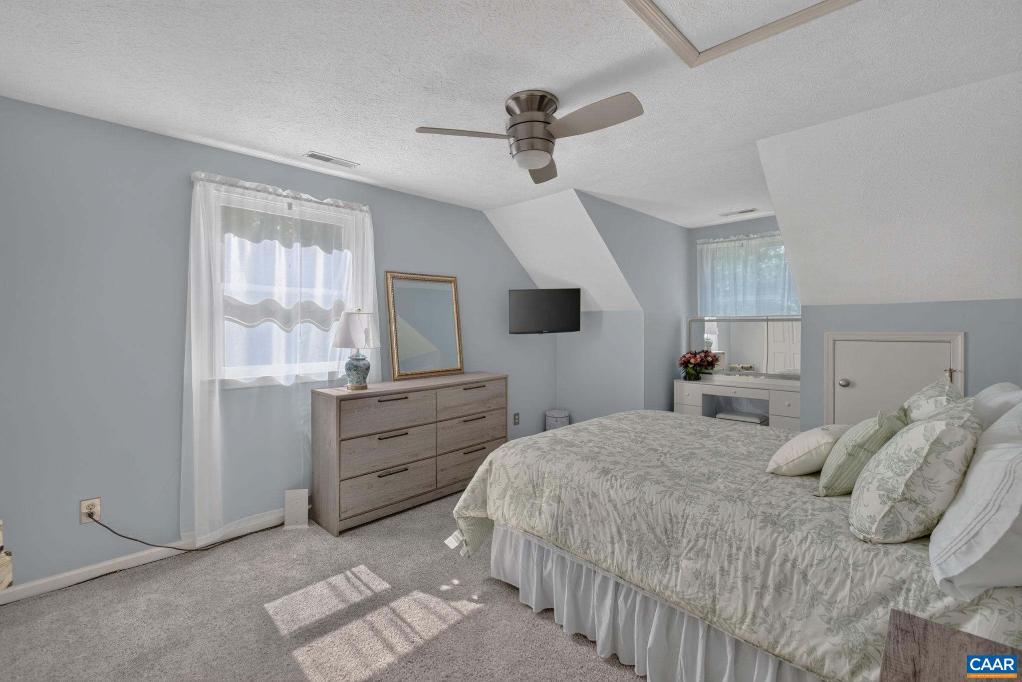 This large bedroom is on the second level. Upstairs is fully carpeted except for the full bath which has tile flooring. There is a large closet plus perfect area for built-ins at the dormer.  Also two small doorways lead to space behind the room.