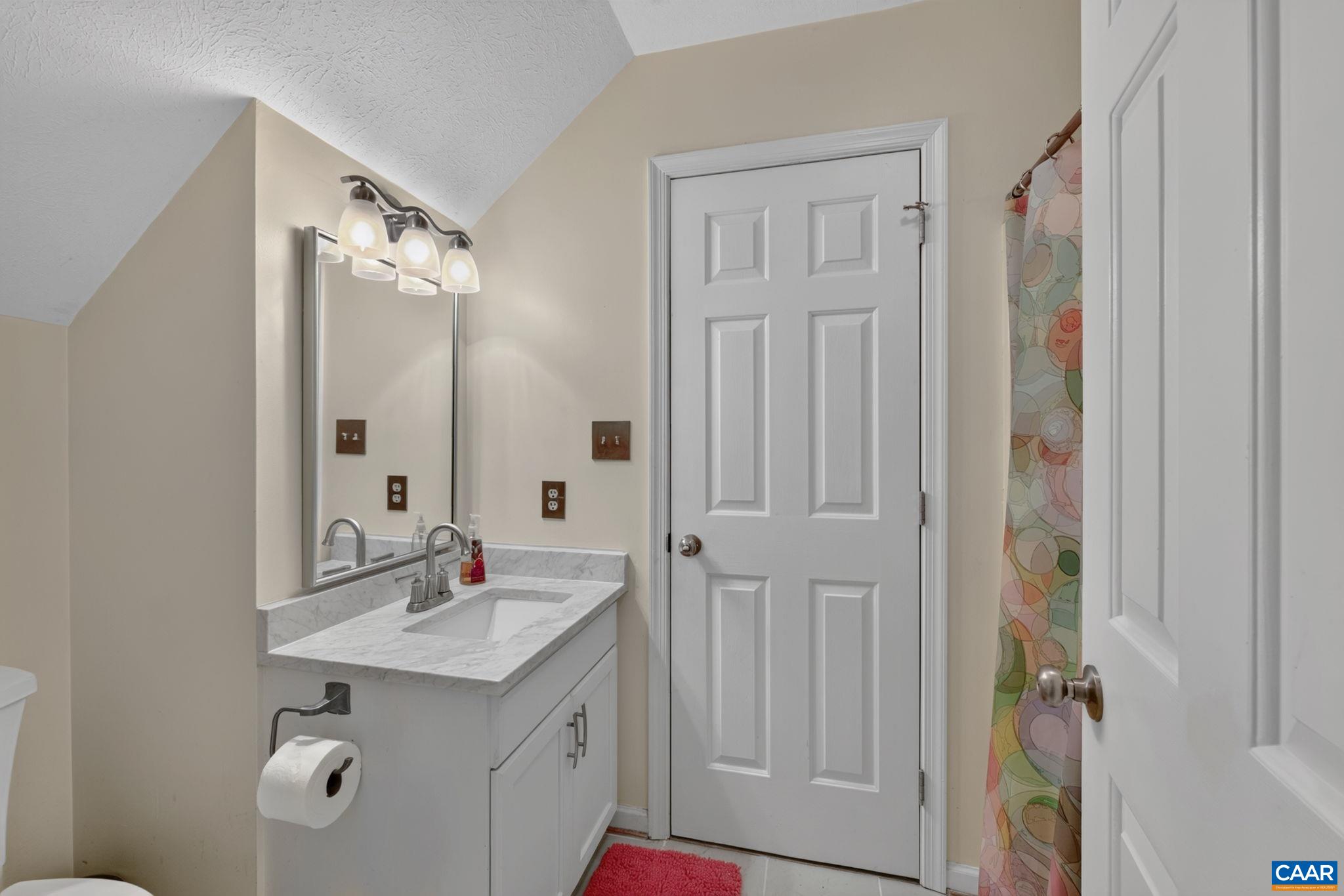 This bath has a doorway leading into the loft plus another secondary bedroom.  The vanity top was replaced 2 years ago as well as the sink, fixtures and lighting.  Flooring is tile.