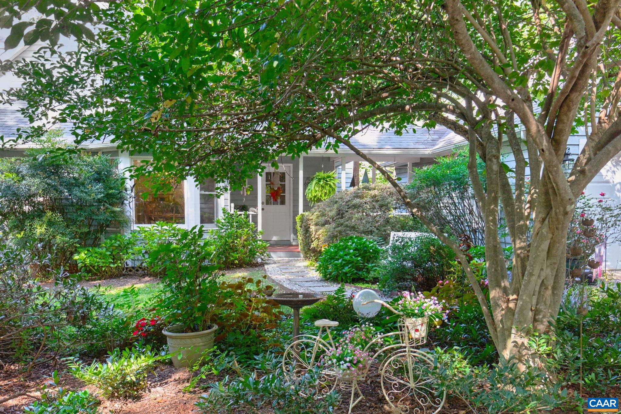 This area is most frequently used to enter the house...it had been professionally landscaped with a Saucer Magnolia, Split Leaf Japanese Maple and many other types of plants.  Also a view of the breezeway leading to the two car garage.