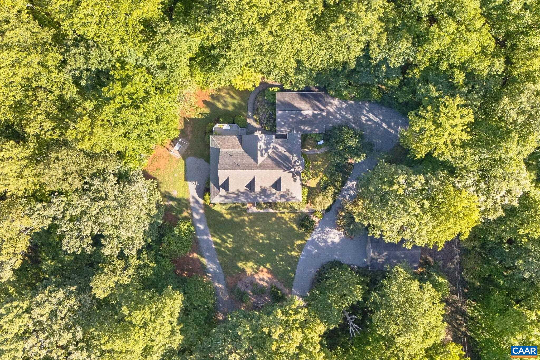 This view shows how the house is nestled in beautiful trees, providing an abundance of privacy and seclusion.