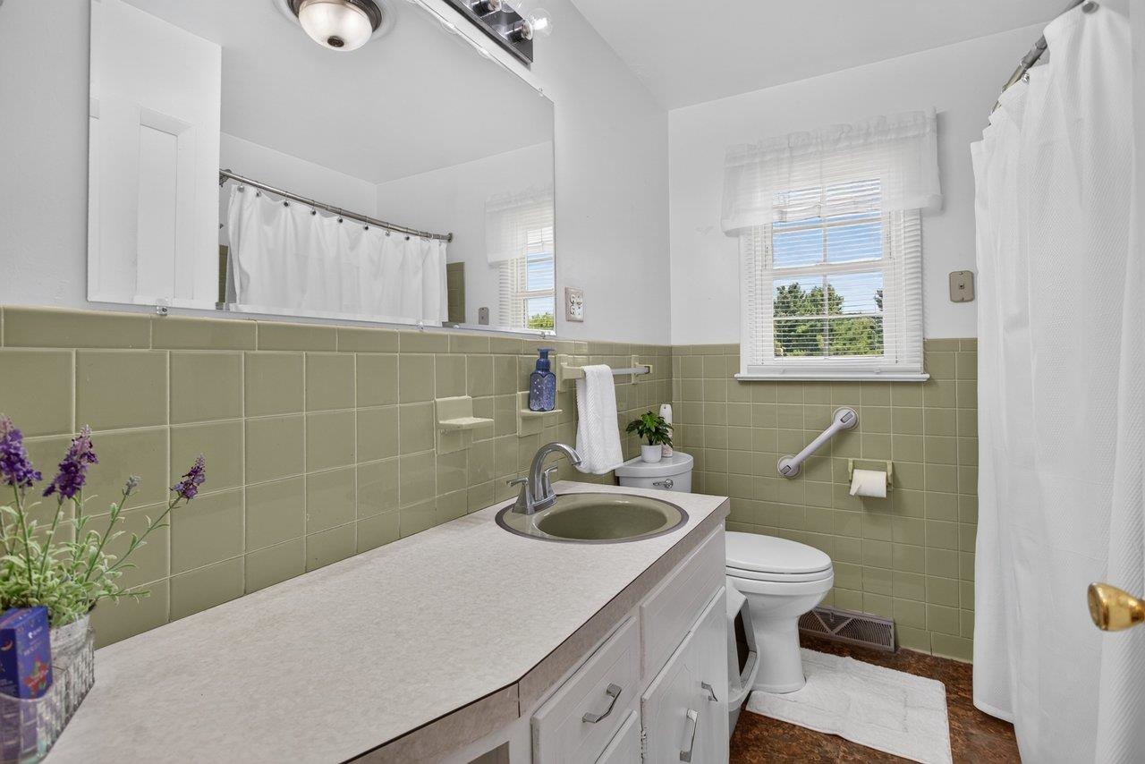 Full bath featuring ample counter space, tub/shower, and classic retro tile. Full bath featuring ample counter space, tub/shower, and classic retro tile.