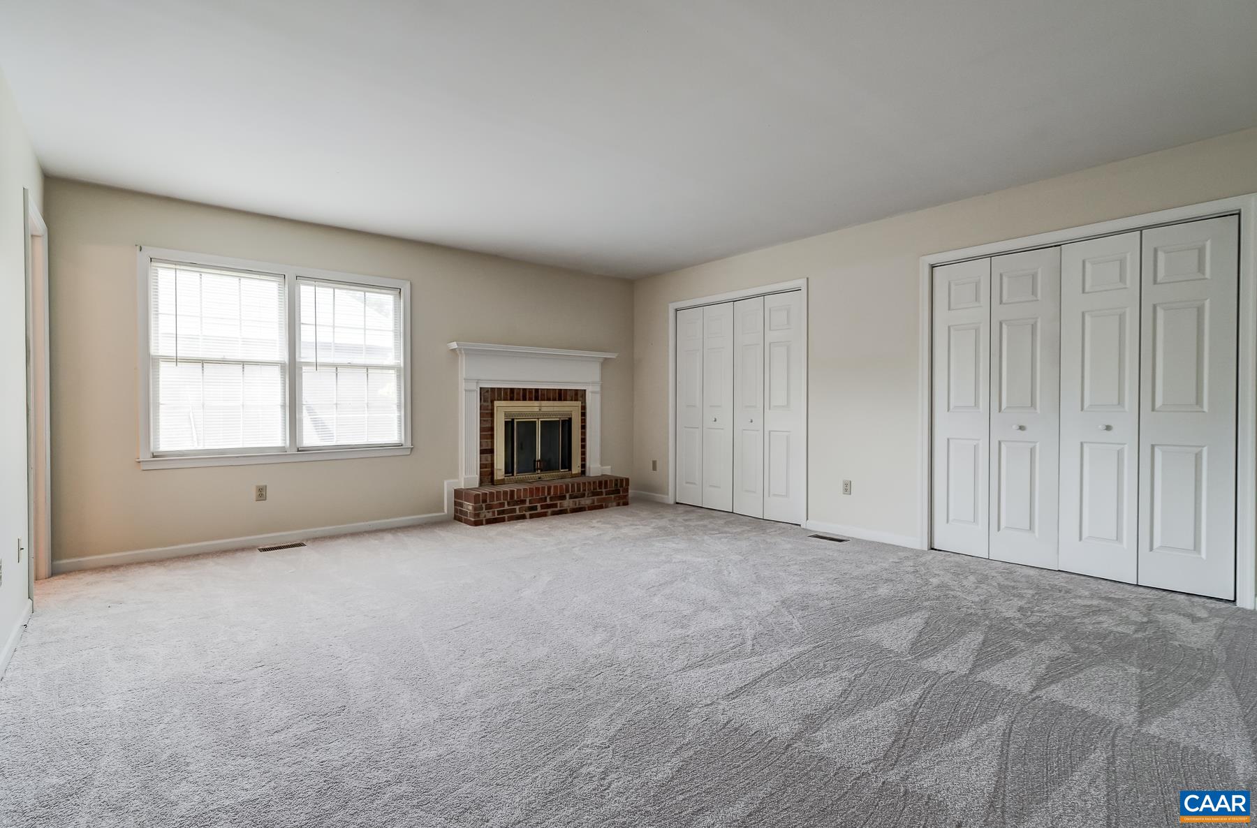 Second floor primary suite features wood-burning fireplace and two closets.