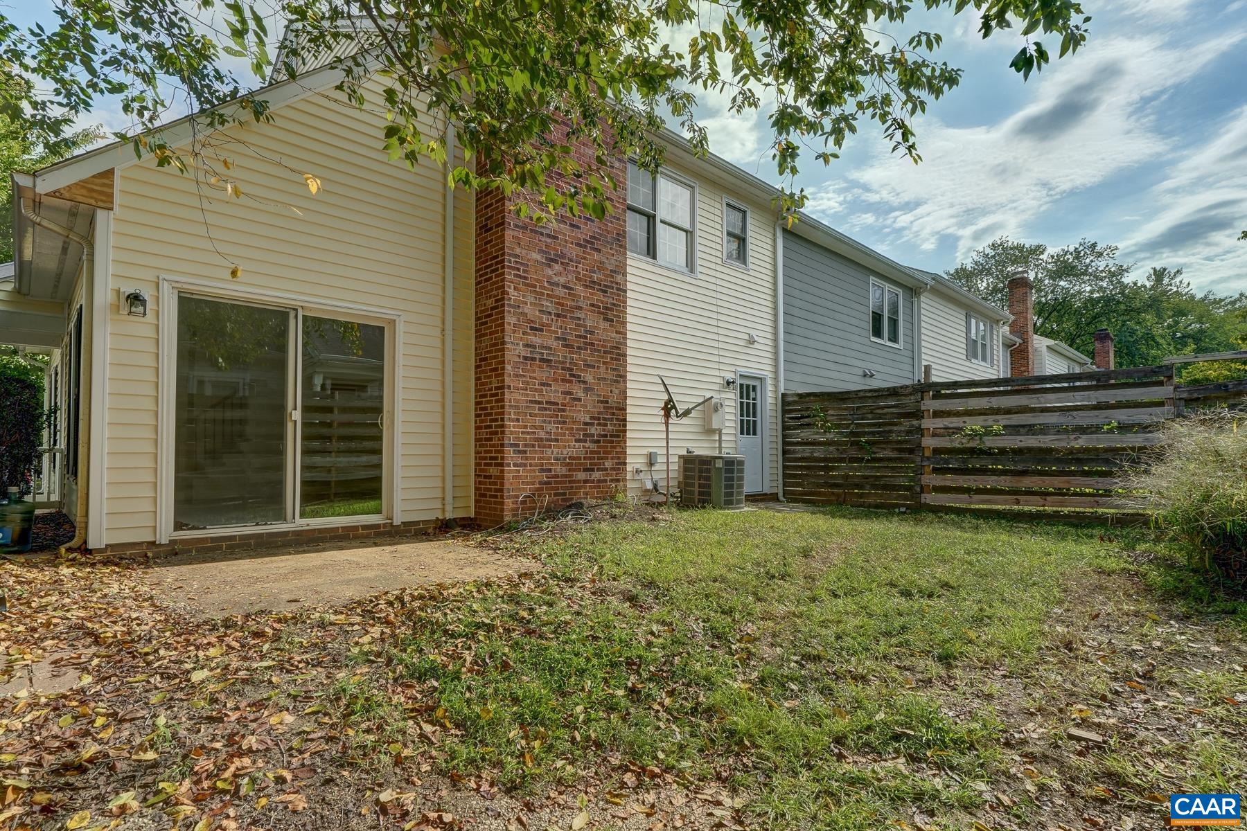 Flat, fenced back yard with patio.