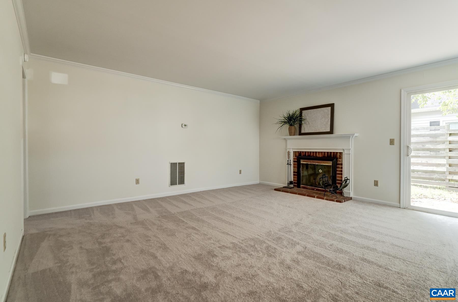 Living room features wood burning fireplace.