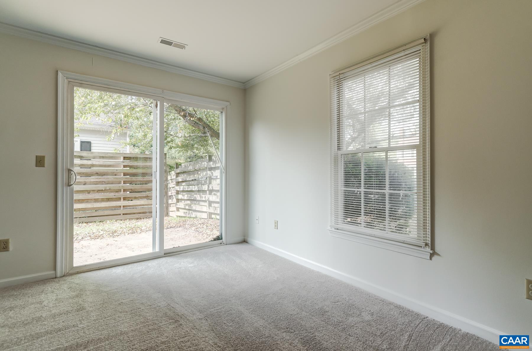 Sliding doors lead to fenced back yard with patio space.