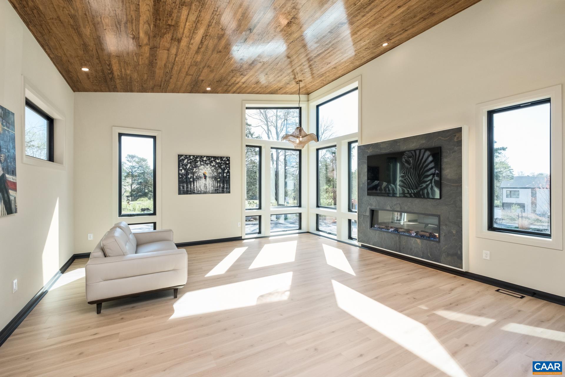Vaulted living room with electric fireplace.