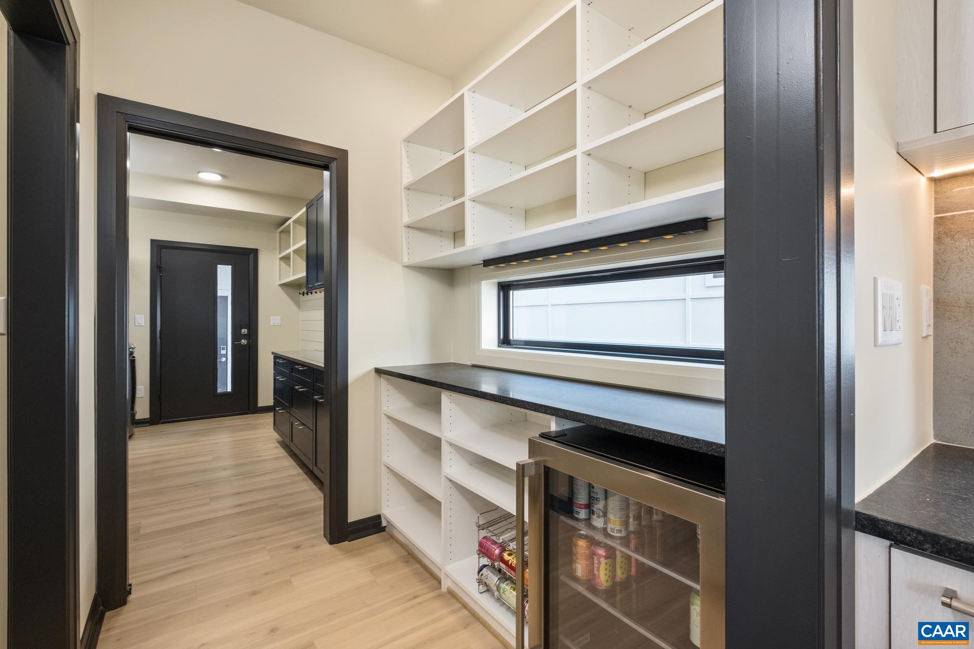 Butlers pantry with appliance counter space and wine fridge.
