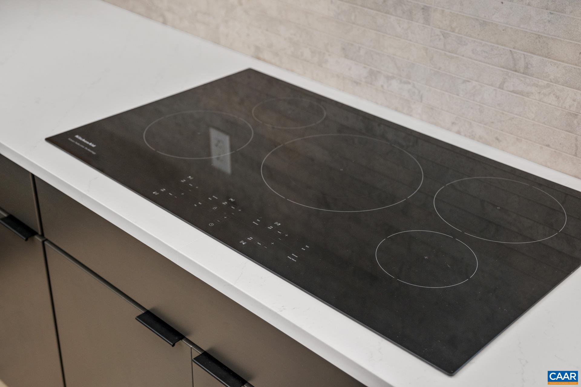 Induction cooktop and tile backsplash are a chefs dream!
