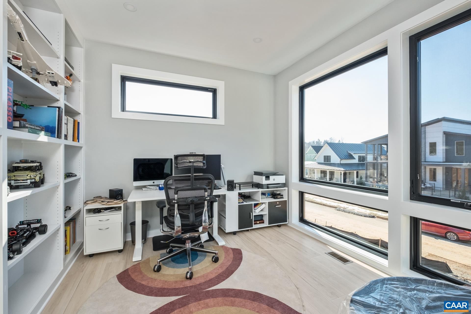 HOme office with built-in bookshelves.