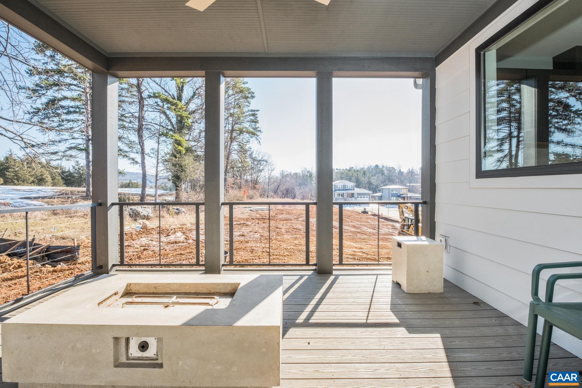 Screened porch overlooks the golf course beyond.