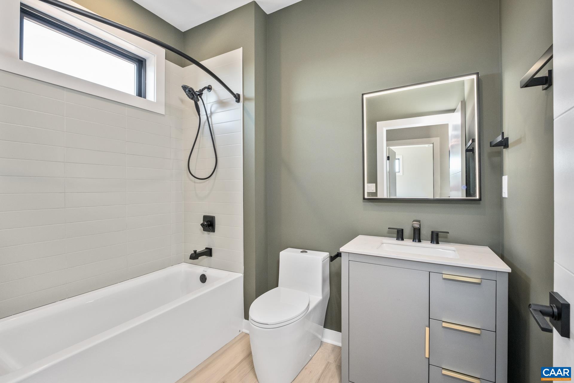 Hall bathroom with tub/shower combo and high end toilet.
