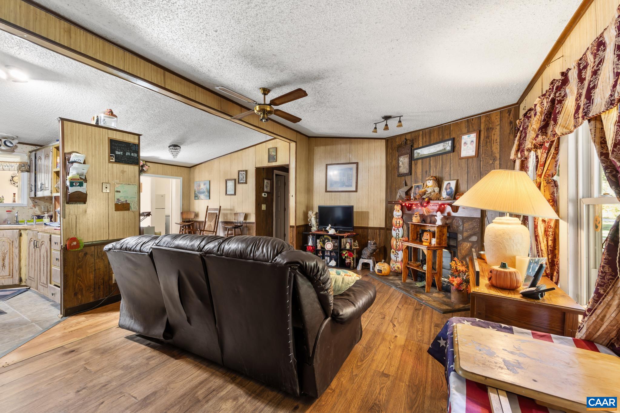 A cozy wood fireplace anchors the welcoming family room, complete with a breezy ceiling fan. Flowing seamlessly into an open kitchen and featuring a formal living room, this home is built for comfortable daily living and effortless entertaining! A cozy wood fireplace anchors the welcoming family room, complete with a breezy ceiling fan. Flowing seamlessly into an open kitchen and featuring a formal living room, this home is built for comfortable daily living and effortless entertaining!