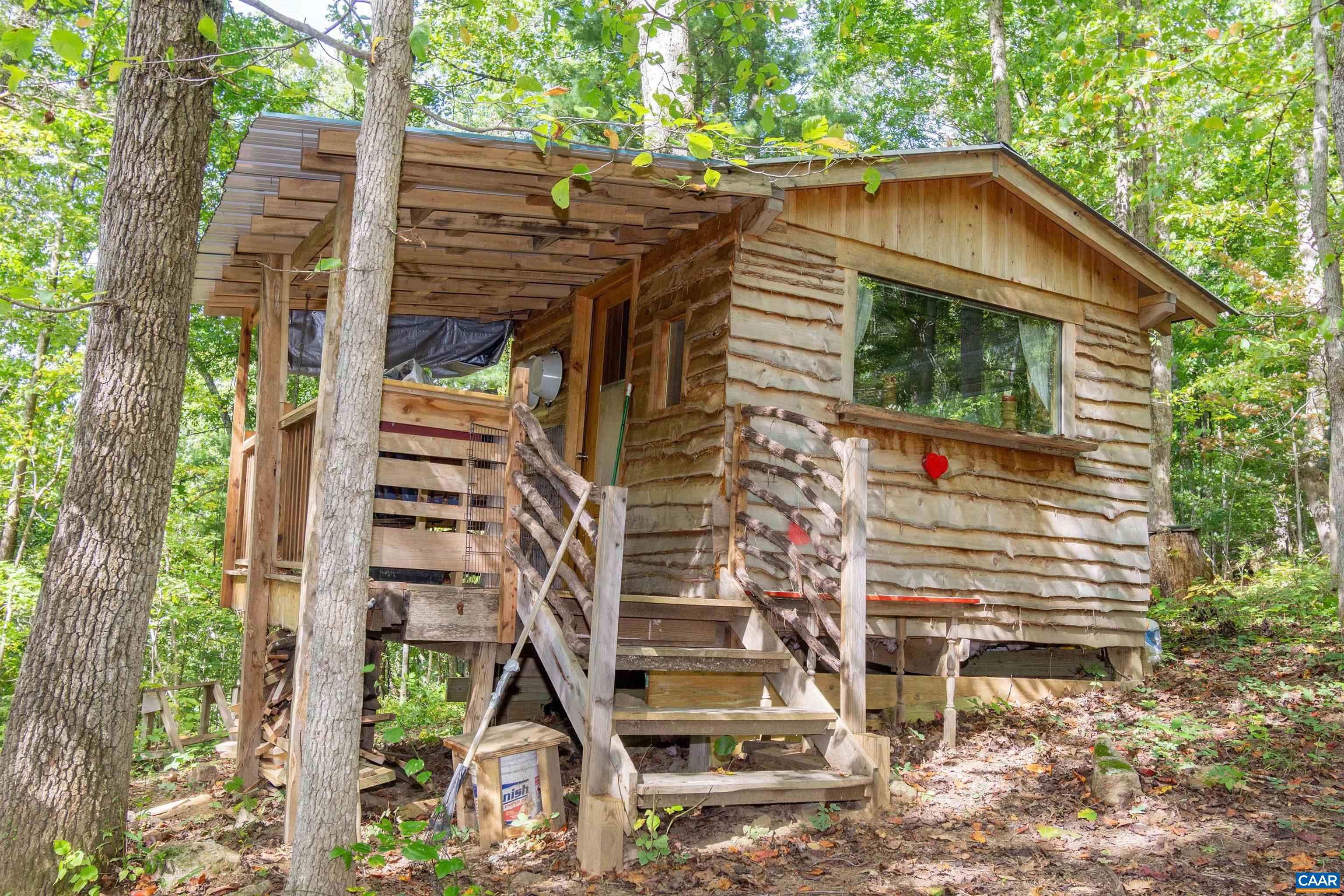 100 yards up the hill from the house, you will find this delightful, one-room cabin with covered front porch. 100 yards up the hill from the house, you will find this delightful, one-room cabin with covered front porch.