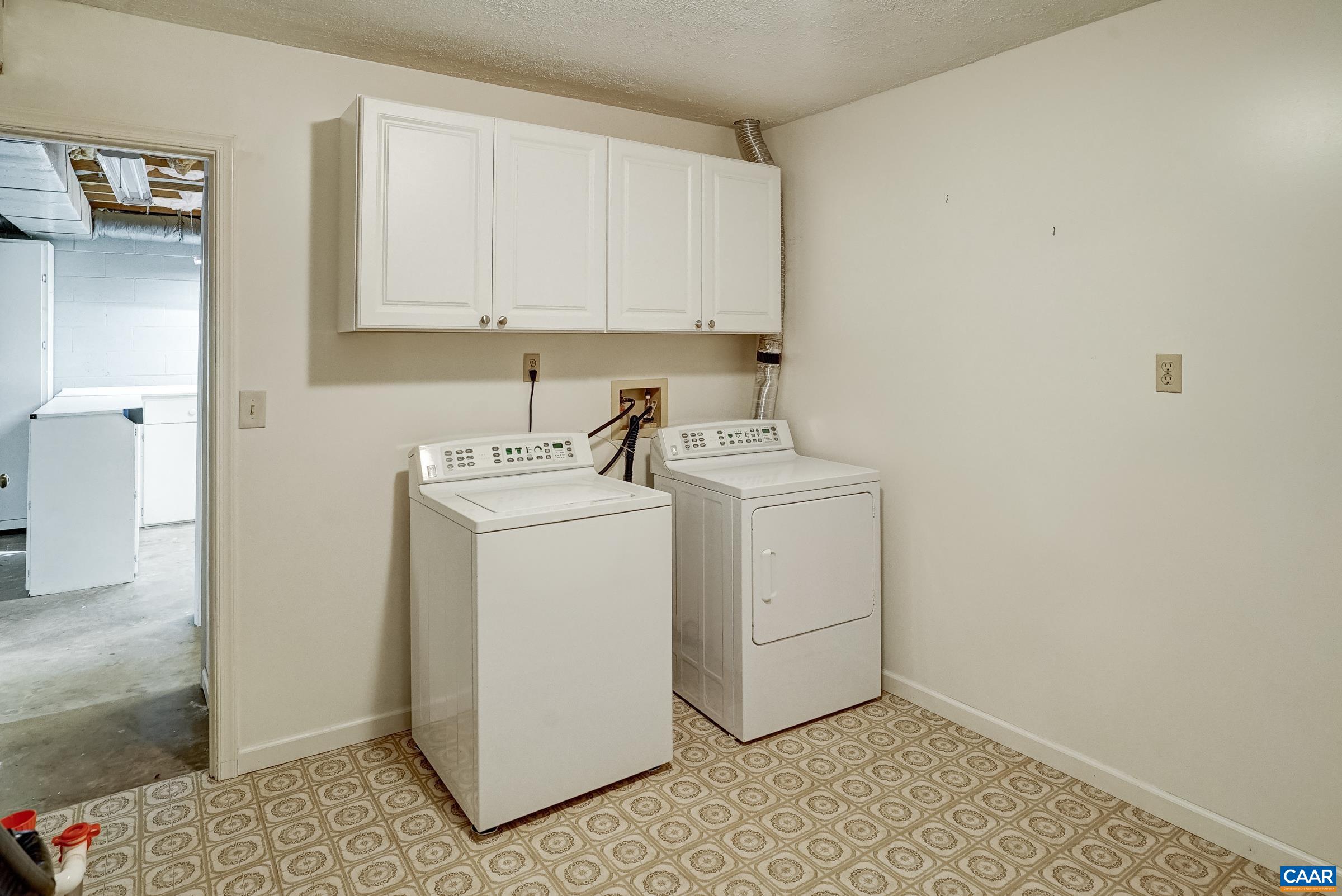 Washer, dryer and stoage cabinets in basement. Washer, dryer and stoage cabinets in basement.
