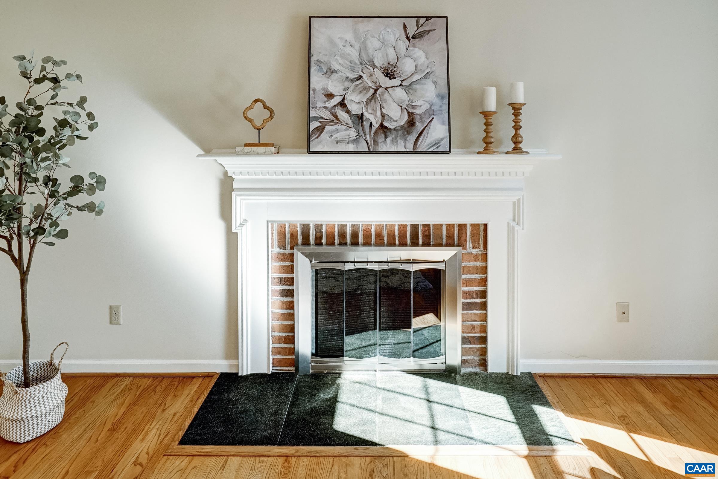 Wood burning fireplace is the focal point of the light-filled living room. Wood burning fireplace is the focal point of the light-filled living room.