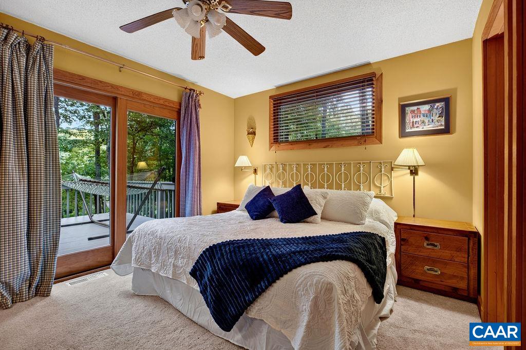 A convenient main-level guest bedroom with direct deck access—ideal for older family members or guests who prefer to avoid the stairs.