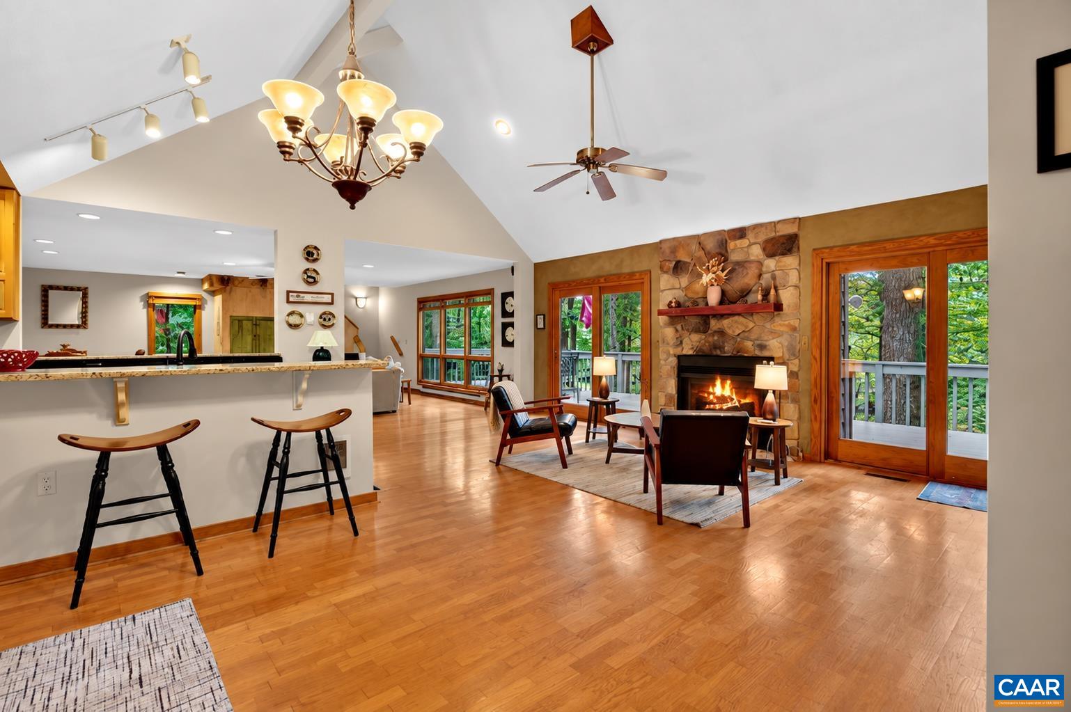 Open and inviting, the kitchen and living spaces flow together with walls of glass, easy access to the expansive deck and golf views, while the wood-burning fireplace creates a cozy mountain retreat.