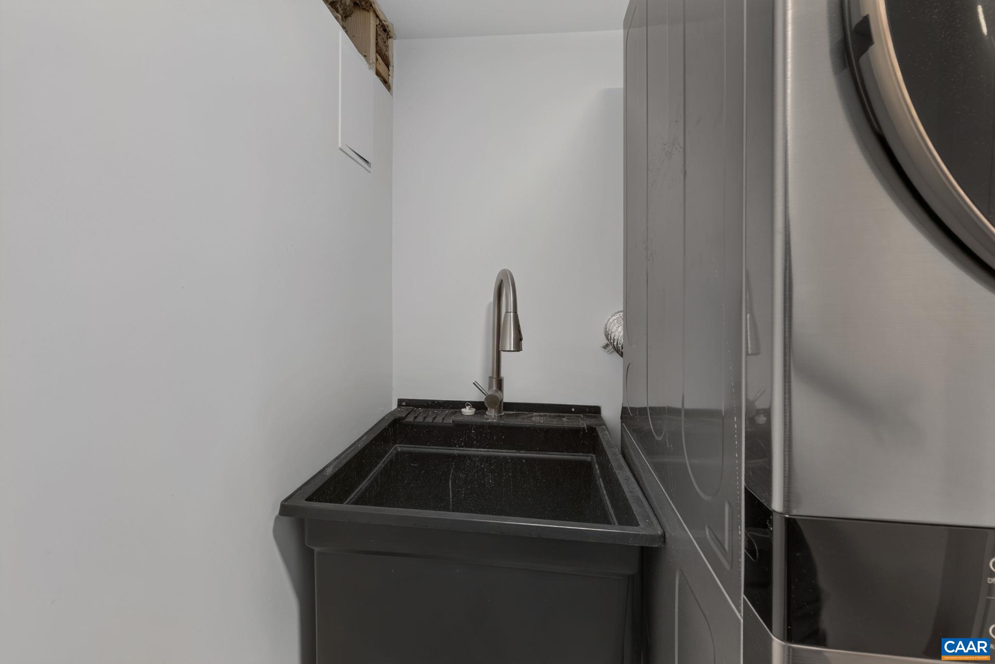 And a laundry sink hidden by a barn door. And a laundry sink hidden by a barn door.