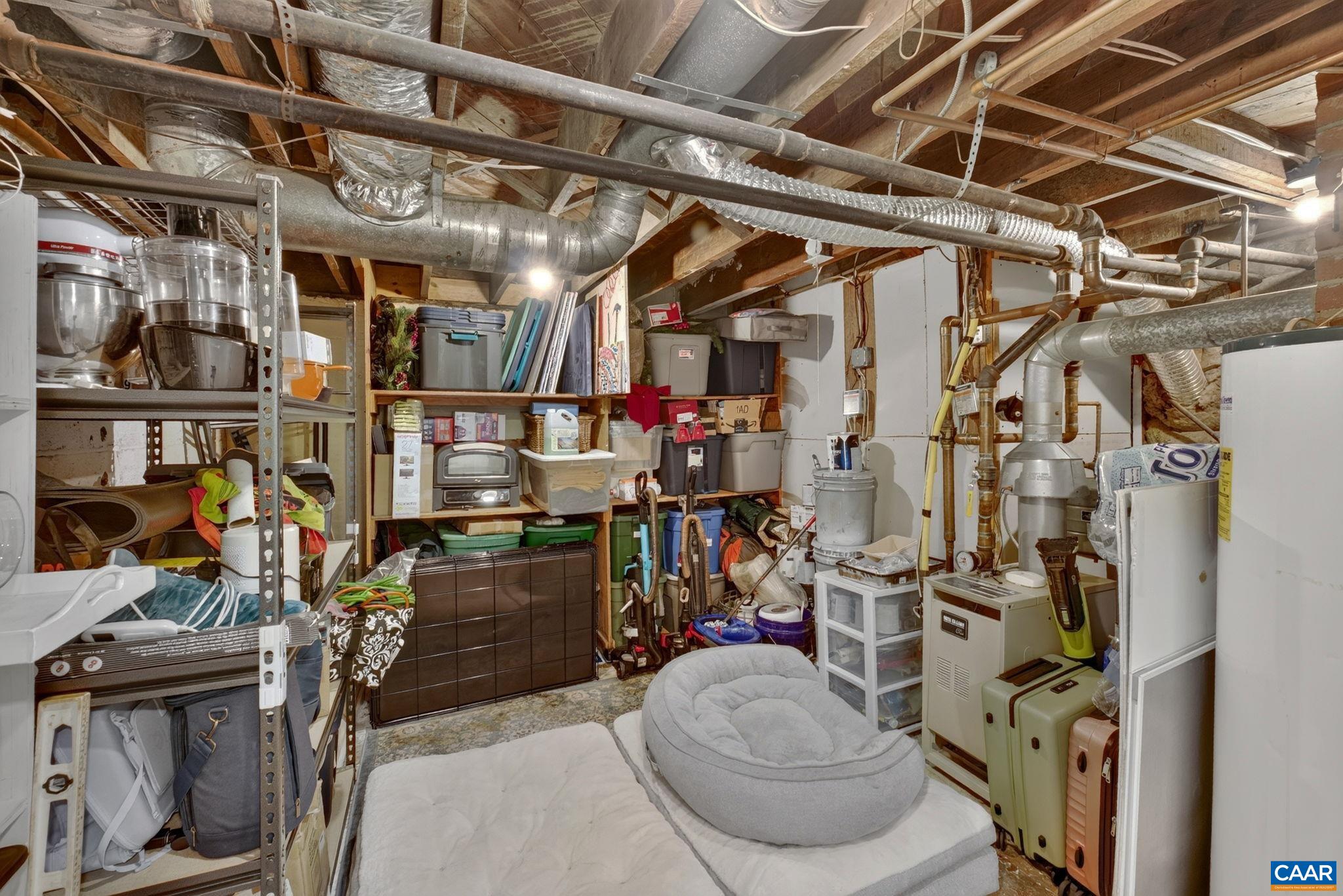 There is unfinished storage/utility space by the stairs. There is unfinished storage/utility space by the stairs.