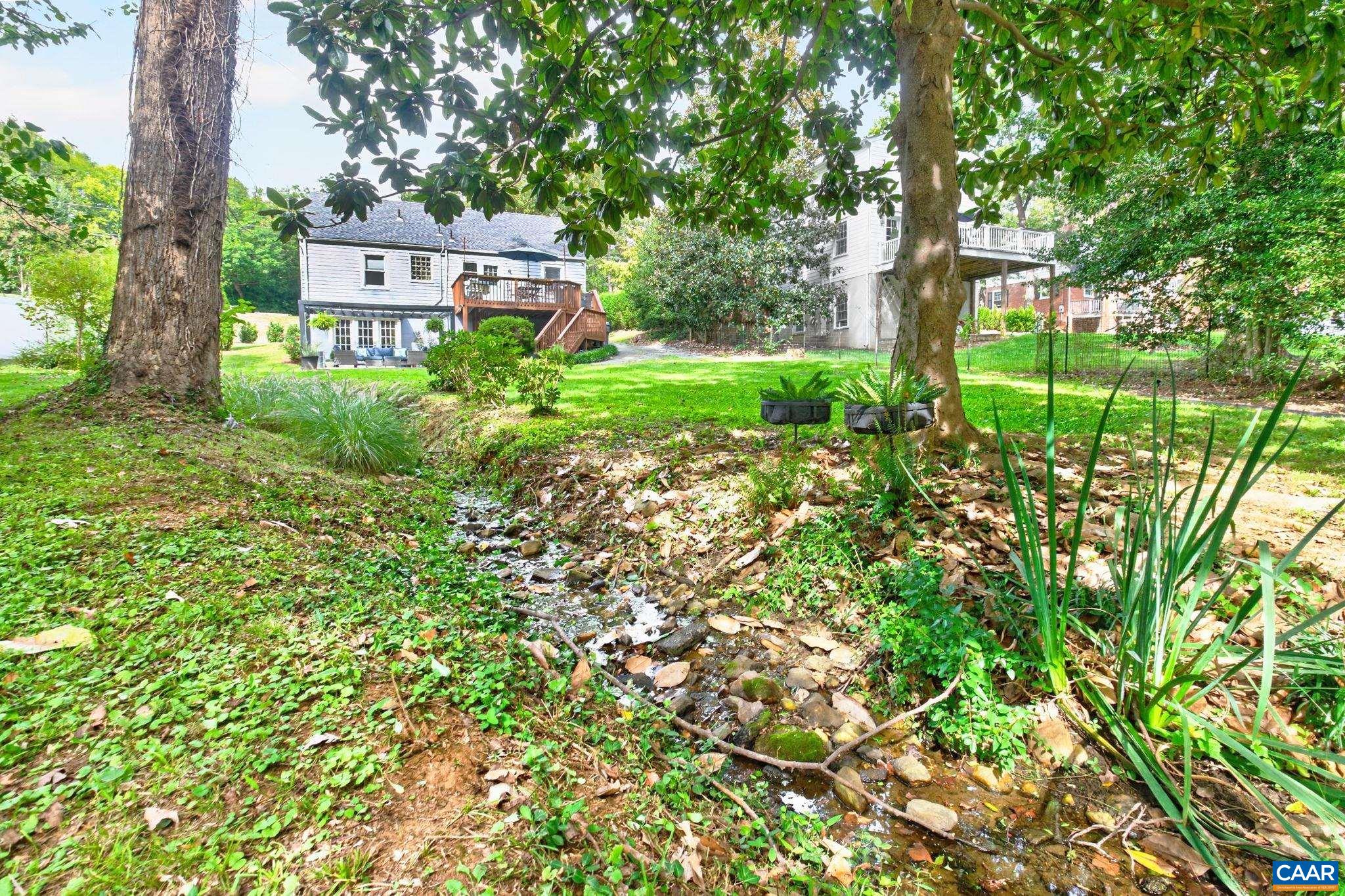 The creek in the yard was fully piped by industrial contractors, including all required City permits. The creek in the yard was fully piped by industrial contractors, including all required City permits.