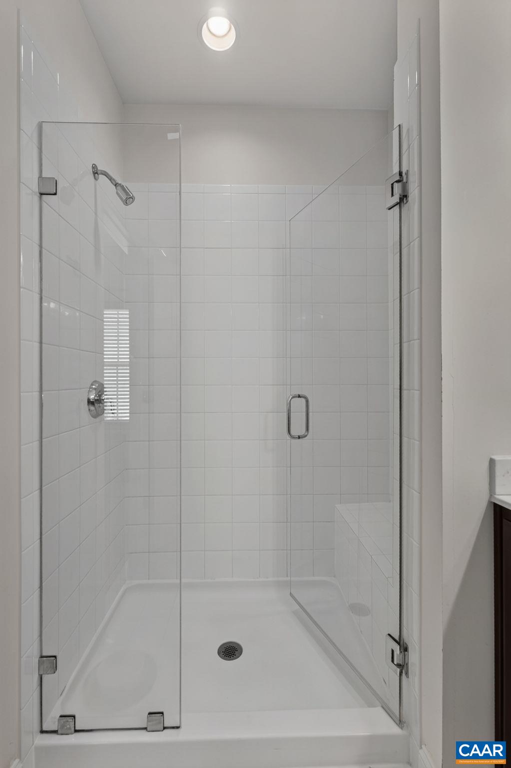 Tiled primary shower. Tiled primary shower.