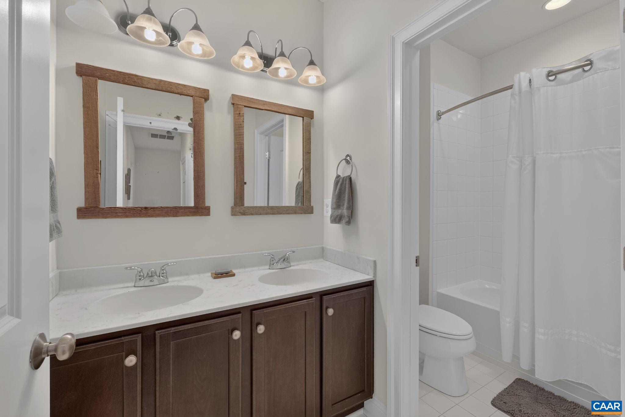 Third level tiled full bathroom with shower/tub and double sink vanity. Third level tiled full bathroom with shower/tub and double sink vanity.