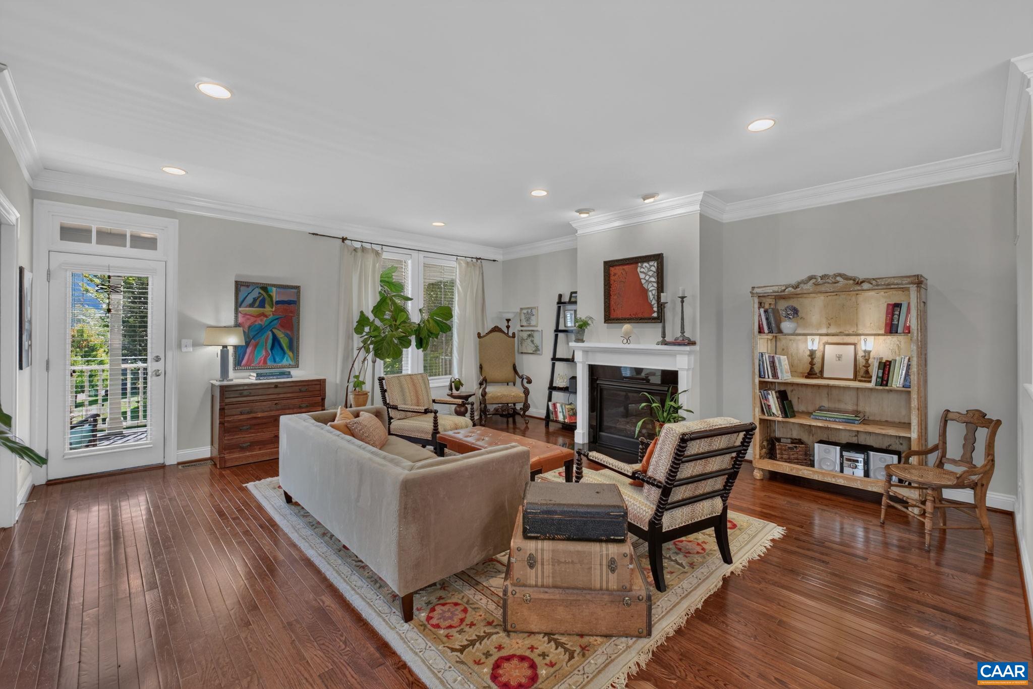 Comfortable living room with gas fireplace and door to the front porch. Comfortable living room with gas fireplace and door to the front porch.
