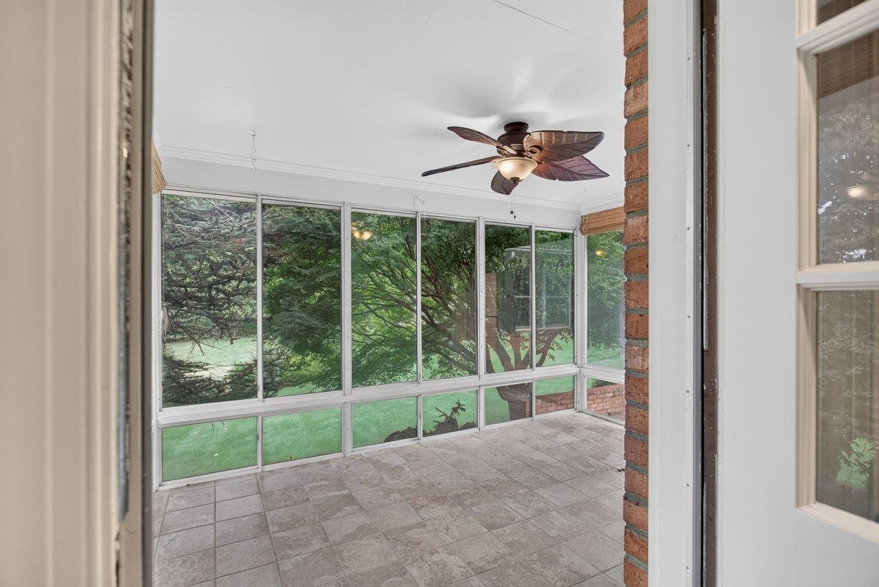 The kitchen leads out on to this spacious sunporch with tiled floor and ceiling fan