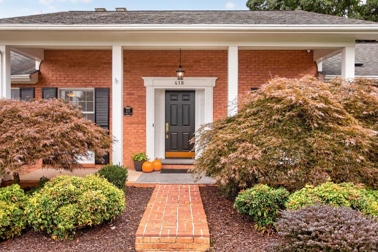 Lovely landscaping and brick walkways surround this graciouis home