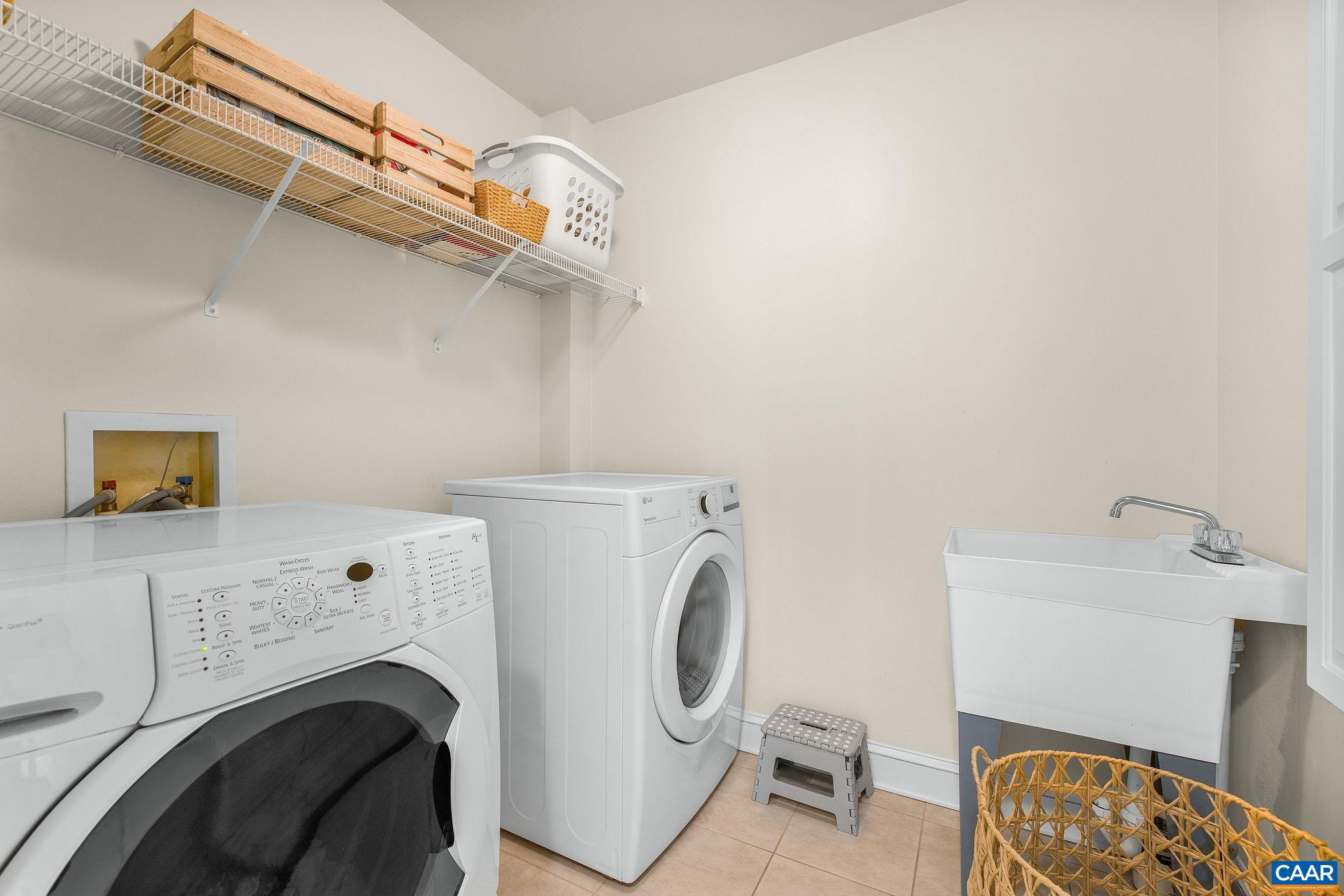 Second-floor laundry room with sink. Second-floor laundry room with sink.