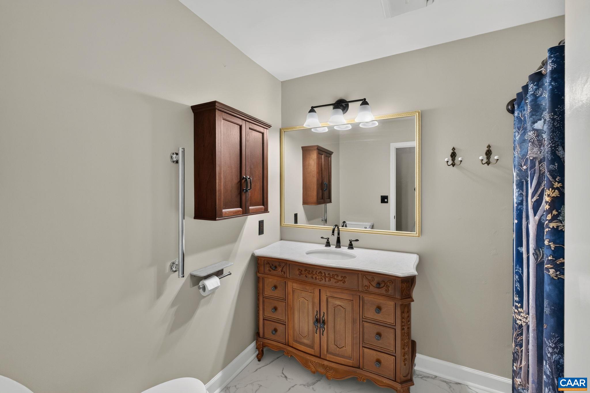 Fabulous double door linen closet outside of bathroom offers plenty of storage